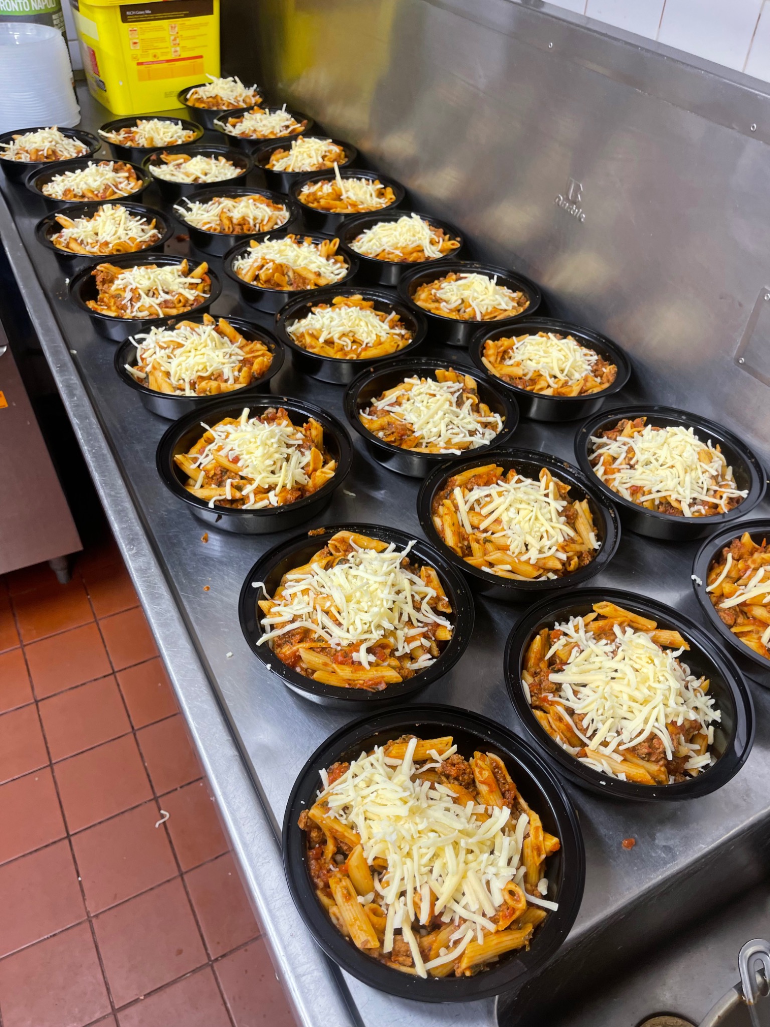A batch of round meal bowls on a kitchen bench