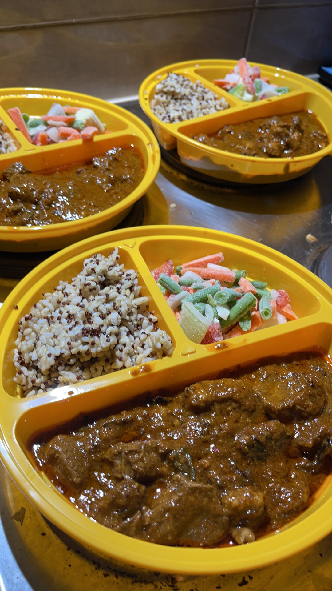 Actual curry meal with rice in a divided meal container